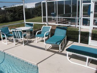 Another view of the fully screened pool complete with loungers for soaking up that Florida Sun